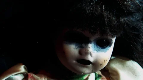 Creepy doll sat up zoom in front shot Stock Footage