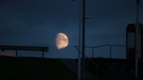 Creepy eerie urban moon rising over traffic overpass stairs walkway Stock Footage