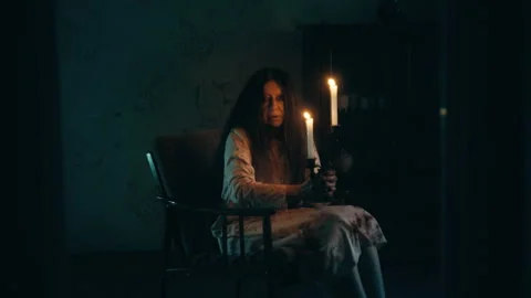 Creepy ghost of black witch sitting in armchair, performing candle magic rituals Stock Footage 260068900