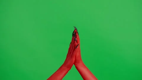 Creepy halloween devil monster hand in red paint with black nails clapping hands Stock Footage 286133703