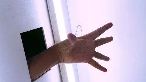 Creepy hand emerging from a dark wall hole in a spooky horror scene, captur.. Stock Footage 342020044