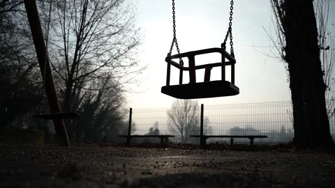 Creepy image of child swing moving alone at misty day, Zagreb, Croatia. Stock Footage 105502986