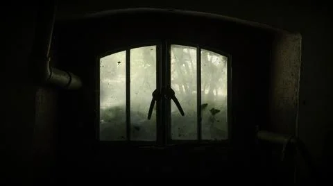 Creepy looking window inside an old house basement Stock Photos