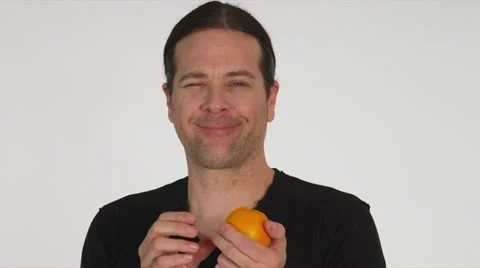 Creepy Man Peels and Eats Orange Stock Footage 35230921