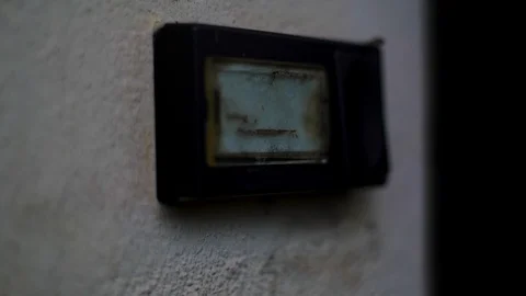 Creepy old door bell nameplate next to dark lonely spooky house without name on Stock Footage 130116341