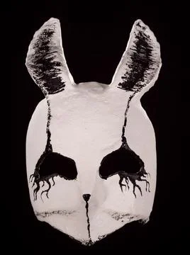 Creepy rabbit muzzle mask isolated on black Stock Photos