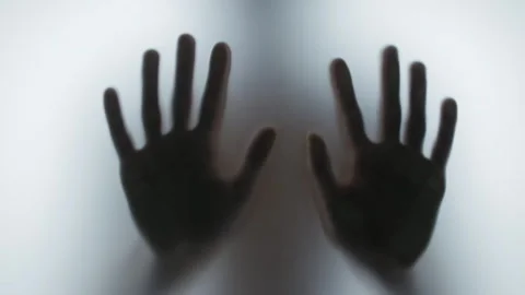 Creepy shadow of human hands sliding on a translucent glass surface. Stock Footage 327158484