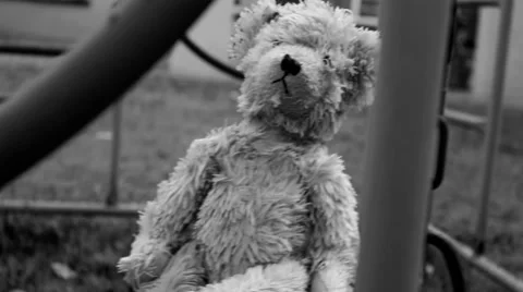 Creepy teddy bear on a swing Stock Footage