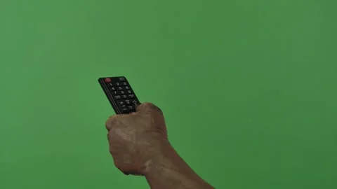 A creepy zombie hand flips through channels on a TV remote Stock Footage 318312347