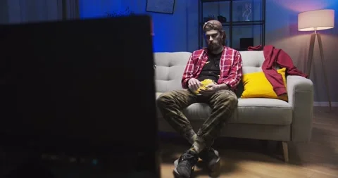 Creepy zombie man sitting on sofa in the house at the Halloween party. Evil Stock Footage 134947341