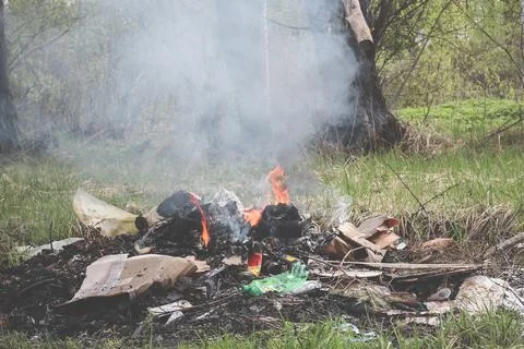 Cremation plastic garbage or trash in open fire. Damage to atmosphere Stock Photos