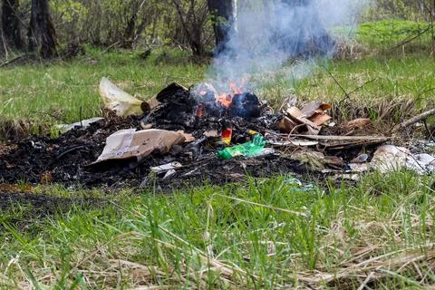 Cremation plastic garbage or trash in open fire. Damage to atmosphere Stock Photos