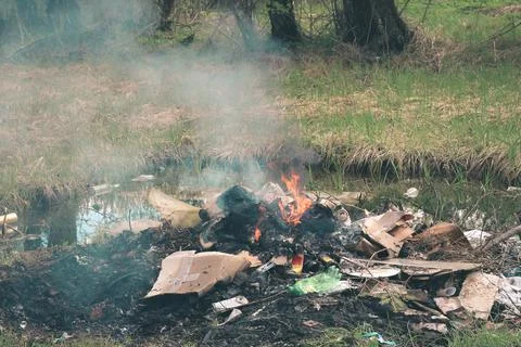 Cremation plastic garbage or trash in open fire. Damage to atmosphere Stock Photos