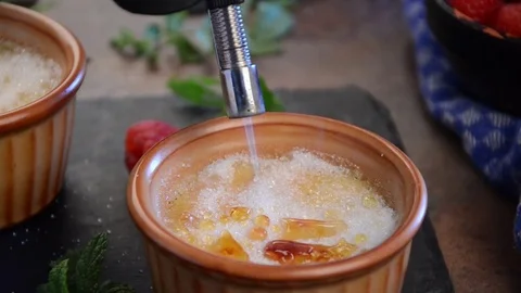 Creme brulee finishing by chef, sugar and torch Stock Footage