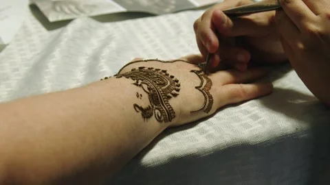 Crenulated temple design drawn with henna on back of hand, mehndi Stock Footage 335127724