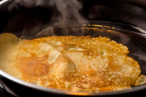 Crepe baking in pan Stock Photos