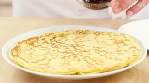 Crepes being spread with jam Stock Footage 24651947