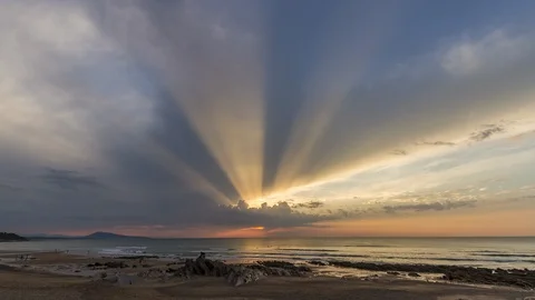 Crepuscular rays on the beach Stock Footage