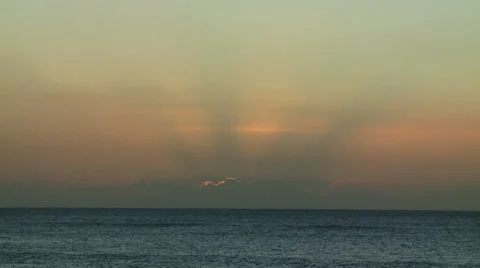 Crepuscular Rays from Sun Setting Behind Ocean Clouds Stock Footage 54709640