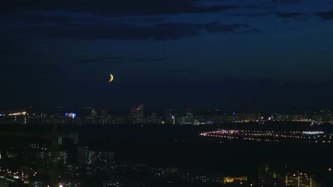 The crescent hiding behind the clouds Stock Footage 168769393