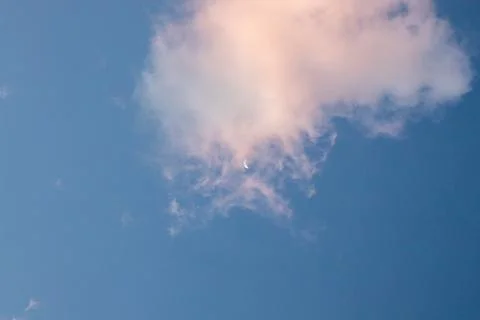Crescent Moon Behind Cloud in Blue Sky Fotos Stock