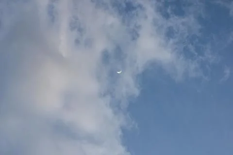 Crescent Moon in a Cloudy Sky Stock Photos