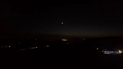 Crescent moon at dark night sky in American rural area. Driving cars on Stock Footage 301054045