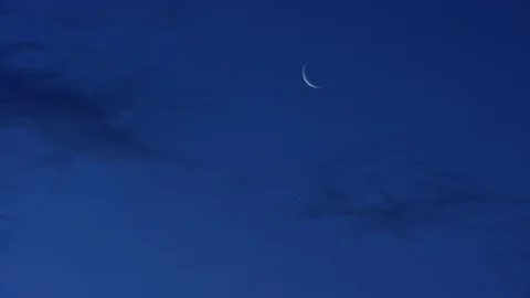 Crescent moon in early dawn dark blue sk... | Stock Video | Pond5