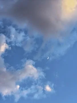 Crescent Moon Framed By Clouds Stock Photos