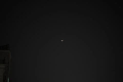 A crescent moon in a night sky Stock Photos
