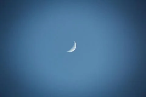 Crescent moon or half moon on day blue sky Stock Photos