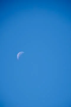 Crescent moon over cloudless blue sky Stock Photos
