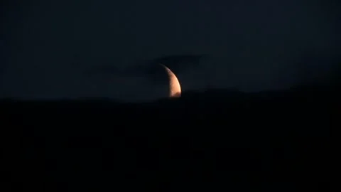 Crescent Moon Sets Behind Passing Veil of Clouds Video stock 277363131