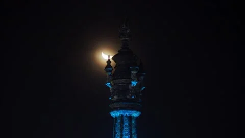 Crescent Moon Setting Behind Bajra Sandhi Monument in Denpasar, Bali Close Up Stock Footage 199751240