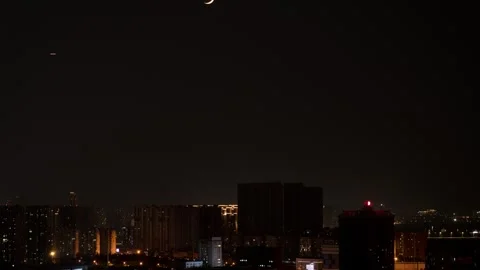Crescent Moon Setting Behind City Skyline at Night Time-lapse Stock Footage 326670326