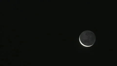 Crescent moon slowly moving in a dark night Stock Footage 336443197