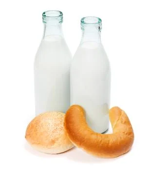 Crescent roll, bun and two old fashioned milk bottles Stock Photos