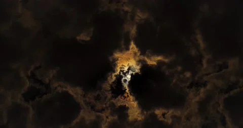 Crescent sun through heavy cloud cover during  a solar eclipse. Stock Footage 198099930