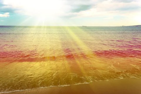 Crest of the beach with sunbeams Stock Photos