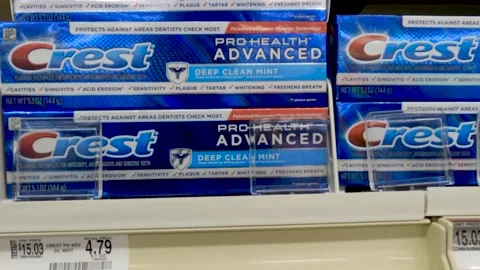 Crest toothpaste on a retail store shelf and price tags Stock Footage 197385902