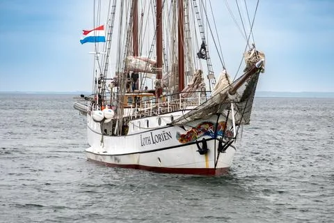 Crew aboard tall ship with rigging and bowsprit Photos