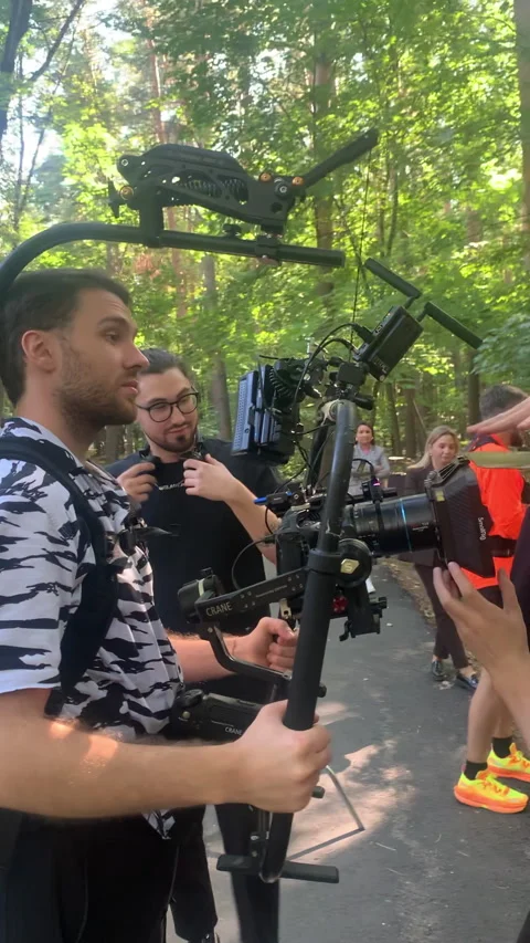 Crew assists operator in securing smooth steadicam rig Stock Footage 313865640