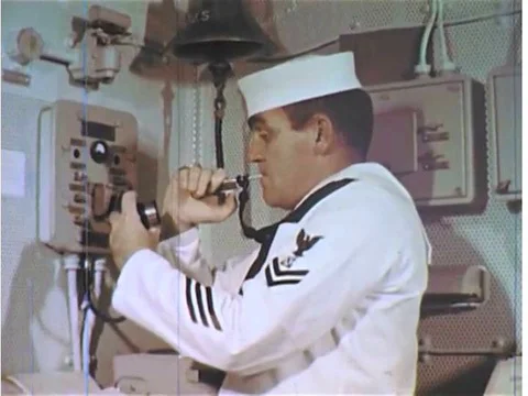 Crew on board the USS Enterprise during the 1960s wake up and prepare for a day Stock Footage 74934458
