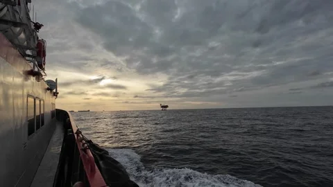Crew boat sailing causing sea waves in the middle of the ocean during sunset Stock Footage 278269448