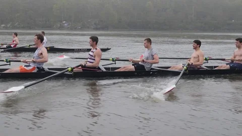 Crew Boats rowing hard upriver Stock Footage