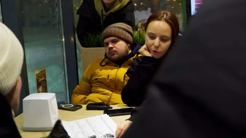 Crew convenes in cafeteria debating ideas for commercial script Stock Footage 303062186
