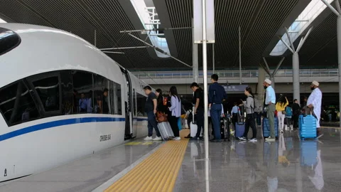 Crew driver and passengers boarding High-speed CRH bullet train Video stock 140480339