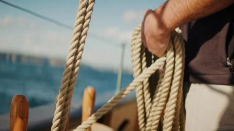 Crew handling sailing ropes on tall ship deck under bright sunlight Stock Footage 330921422