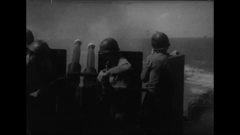 Crew loads and fires gun mount; flame crashes on deck of aircraft carrier - 1944 Stock Footage 102845140