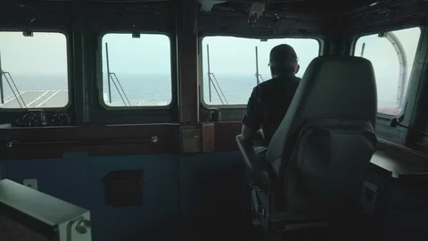 Crew member looking out of window of navy ship Video stock 95796107